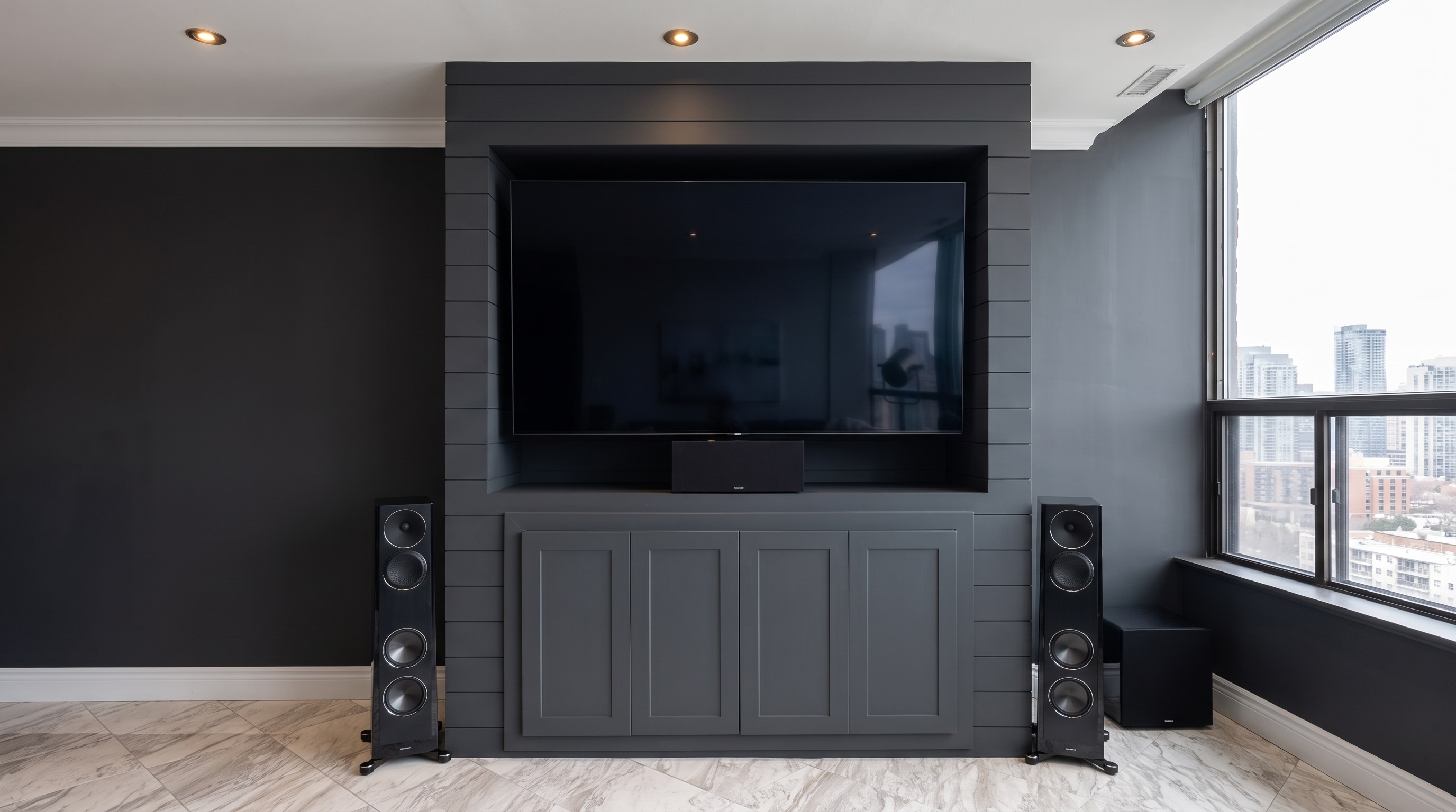 Custom charcoal media wall with integrated cabinetry